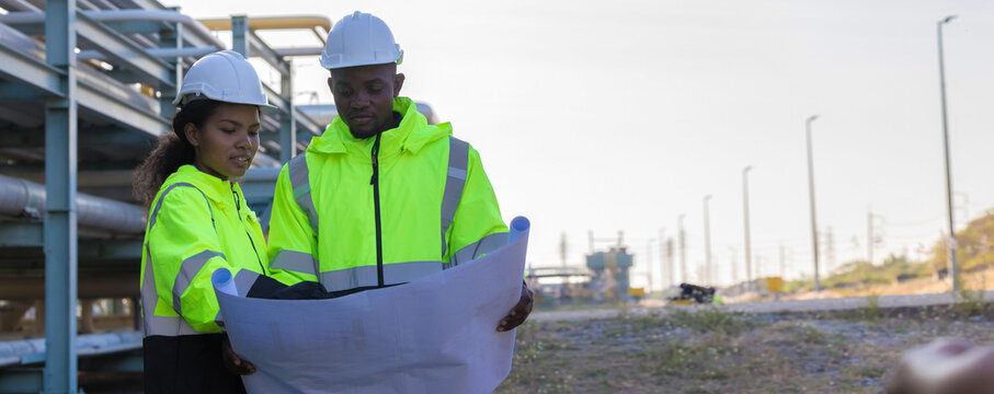 Engineer survey team checking construction project inspection work construction site .Team Civil engineer working outdoor next to the power plant.