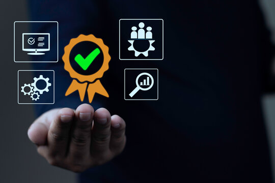 Businessman hand presenting quality assurance QA guarantee badge with ISO certification icons, standard operating procedure SOP, and quality control QC process on dark background.