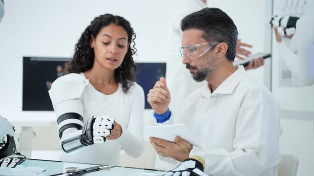 A research team evaluates advanced robotic prosthetics in a modern laboratory, testing functionality and writing notes on a tablet to achieve technical progress and innovation.