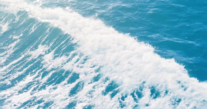 Ocean sea blue wave background. Surface of tropical empty wake of moving water in motion on sunny summer day.