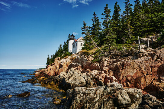 The iconic Bass Harbor Head Light Station (built 1855) perched on rugged pink granite cliffs within Acadia National Park on Mount Desert Island, Maine, New England