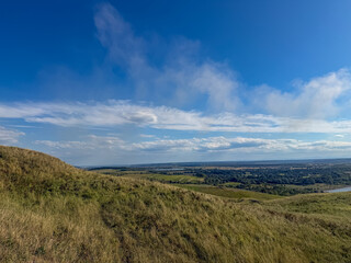 Fototapeta premium Rolling Green Hills and Dramatic Blue Sky in Ukrainian Countryside