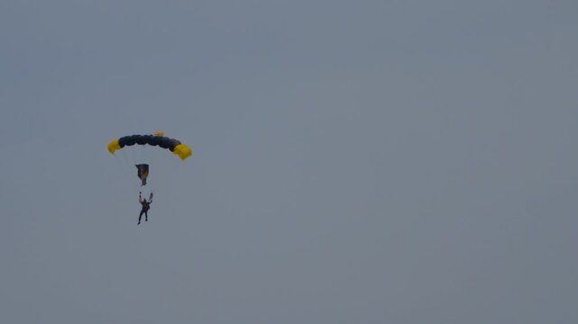 skydiver floating to the ground with a parachute