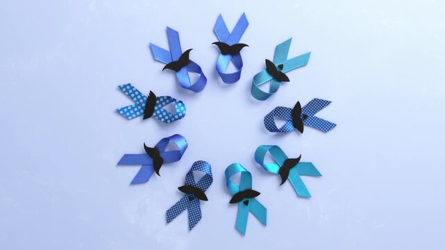 Circle of blue ribbons with black paper mustaches rotating on a white background. Men's health and prostate cancer awareness concept