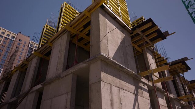 Concrete building structure with yellow formwork under construction