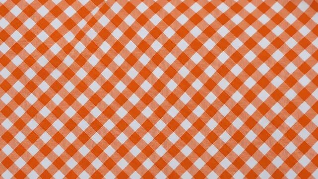 Orange and white checkered fabric cloth waving in gentle motion