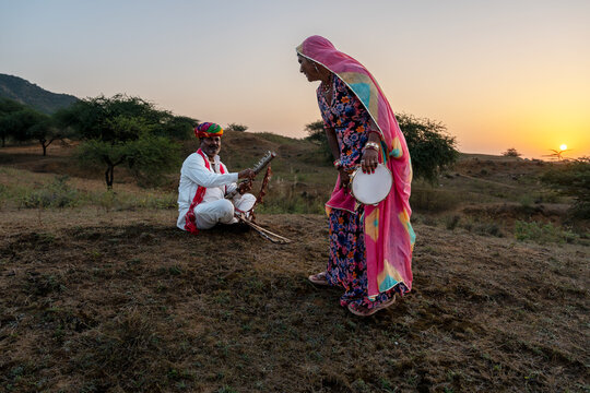 Rajasthani folklore musician and singer with ravanahatha and Khanjari Dafli instrument in Pushkar Rajasthan India
