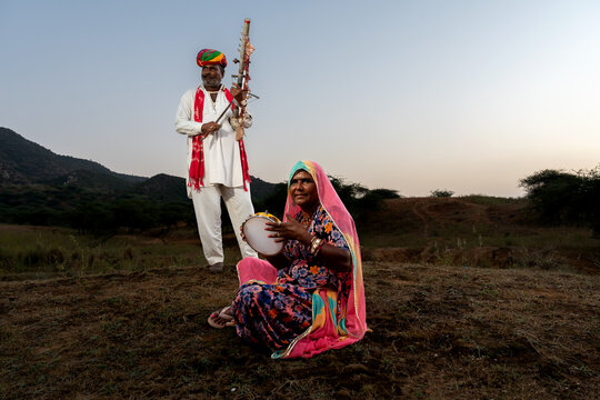 Rajasthani folklore musician and singer with ravanahatha and Khanjari Dafli instrument in Pushkar Rajasthan India