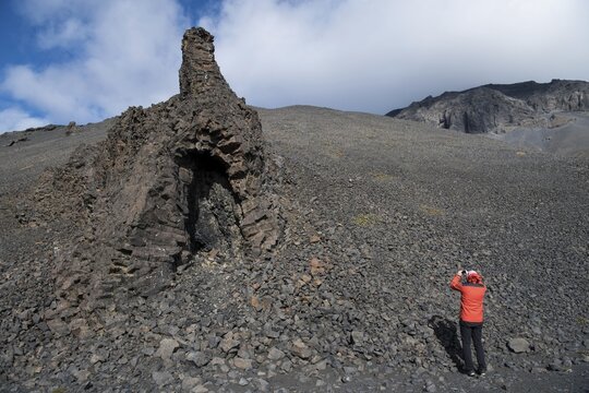 Tourist photographing volcanic vent at the table volcano Her&eth;ubrei&eth; or Herdubreid, Icelandic Highlands, Iceland