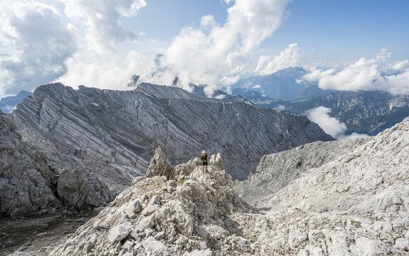 Hiker in a boulder field, hiking to the Hochkalter, Berchtesgaden Alps, Berchtesgadener Land, Upper Bavaria, Bavaria, Germany