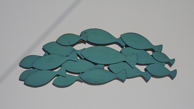 Green wooden fish as wall decoration on light background, Syrmata, boat garages, boathouse, boathouses, beach house, Goupa, Goypa, Goupa Kara, Kimolos, Cyclades, Greek Islands, Greece