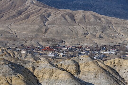 Lo Manthang, capital of Upper Mustang, viewed from a distance amidst a barren desertic landscape, Kingdom of Mustang, Nepal