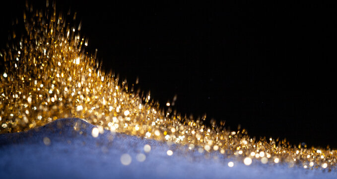 Flying Gold Glitter on Dark Fabric