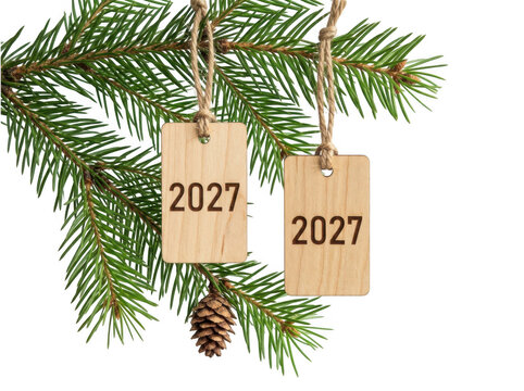 Wooden tags with 2027 year hanging on pine tree branch cutout