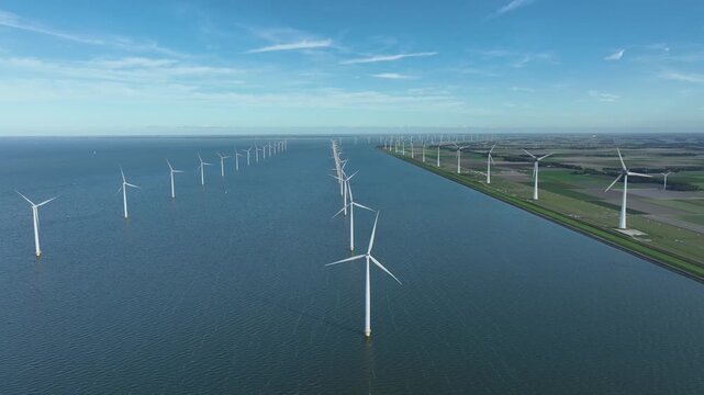 An aerial tour of Windpark Noordoostpolder, recorded from above the waters of the IJsselmeer in Flevoland, The Netherlands.