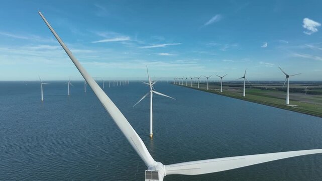 An aerial tour of Windpark Noordoostpolder, recorded from above the waters of the IJsselmeer in Flevoland, The Netherlands.