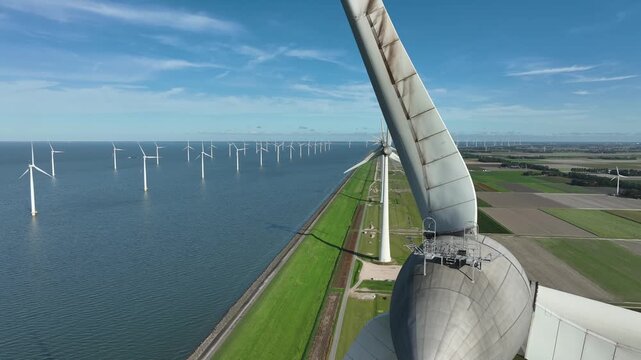 An aerial tour of Windpark Noordoostpolder, recorded from above the waters of the IJsselmeer in Flevoland, The Netherlands.
