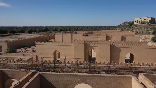 Low-altitude drone view of the reconstructed walls and gate of ancient Babylon, Iraq