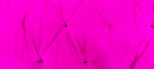 Fototapeta premium Hot pink velvet tufted upholstery texture background with quilted fabric buttons and elegant folds