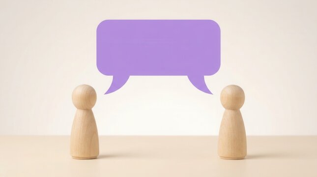 Two wooden figures face each other with a purple speech bubble above.