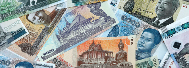 Cambodian riel money banknotes pile on table. Cambodia bills of KHR currency close up © Larysa