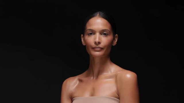 Elegant Woman Subtly Turns Her Head While Posing Against a Black Studio Background