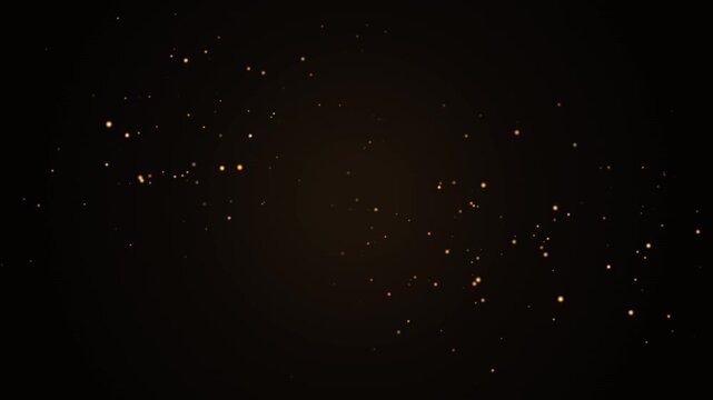Golden glittering dust particles floating on dark background creating cinematic luxury atmosphere.