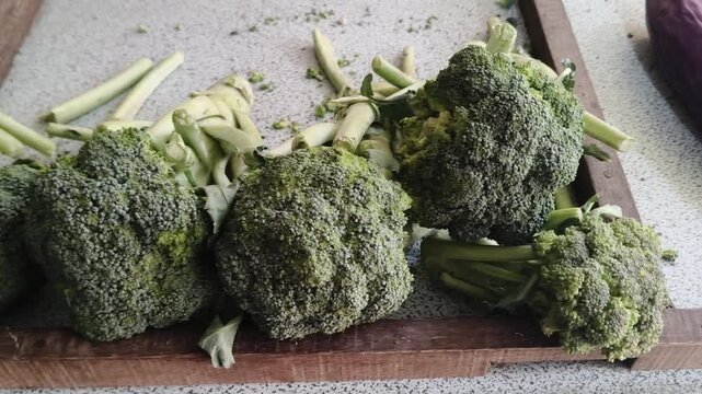 Fresh organic broccoli heads on surface