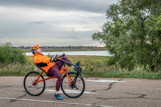 senior cyclist with a road recumbent bike on a parking lot in Boyd Lake State Park, Colorado
