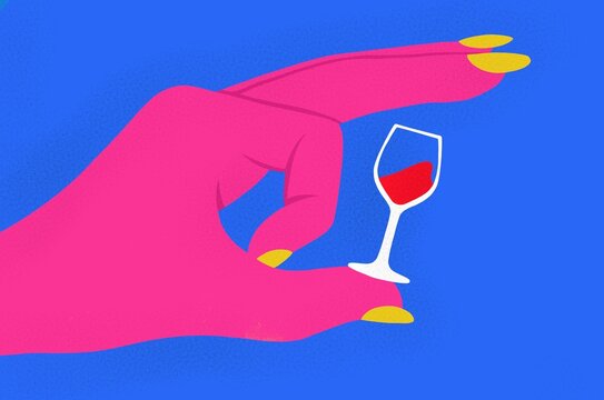 A hand flicking a glass of wine