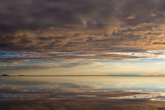 The Uyuni Salt Flat And Its Mirrored Marvels At Sunset