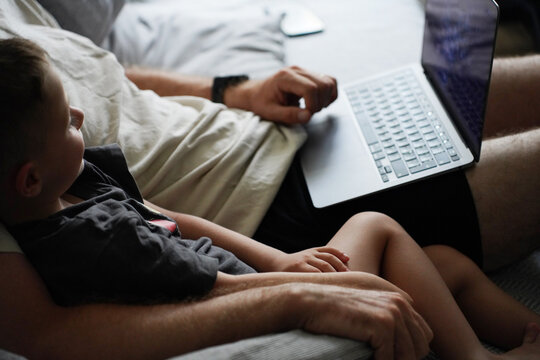 Close-Up of Father and Son Relaxing with a Laptop