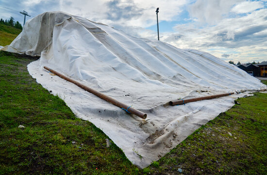 Artificial snow farming - ski resort preserves snow from melt in heat