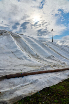 Artificial snow cover - tarpaulin protects ice from summer heat melt