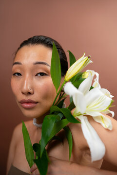 Asian Woman Holding a Lily Flower