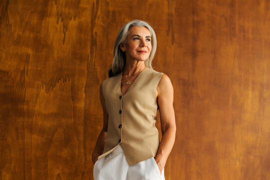 Senior woman confidently standing, looking away