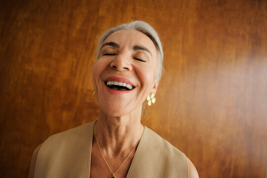 Senior woman laughing eyes closed showing happiness and joy