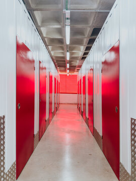 Red doors in modern self-storage facility corridor