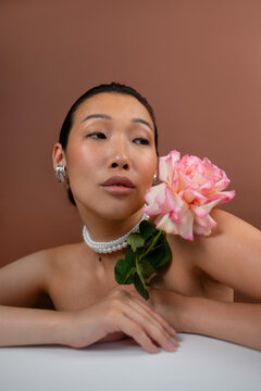 Sensual female portrait with a flower