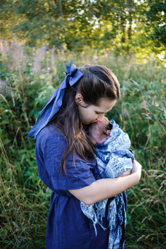 Mother Holding Baby in Nature During Daytime