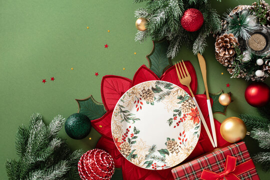 Christmas table setting with plate and holiday decoration