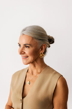 Elegant woman with gray hair smiling confidently
