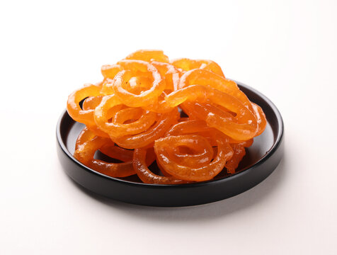 Jalebi  Indian sweet made by deep-frying spirals of fermented batter until crisp and golden, then soaking them in fragrant sugar syrup. Crisp on the outside, juicy and sweet within