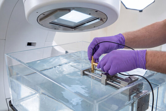 Technician Adjusting Probe in Water Tank for Scanner Testing