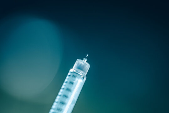 Basal insulin with needle tip and drop in macro close-up
