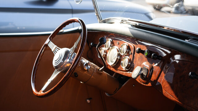 Vintage Classic Car Interior With Wooden Steering Wheel And Dashboard