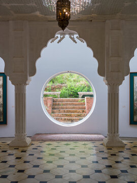 Close-up of ornate arched doorway with circular window and carved stone pillars