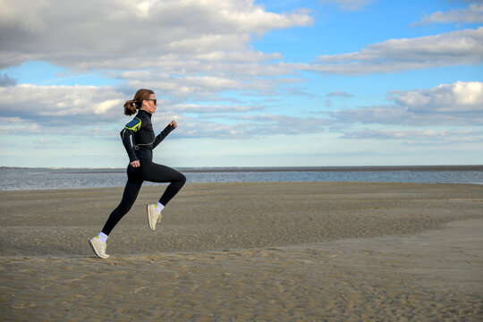 Woman Running on Sandy Beach