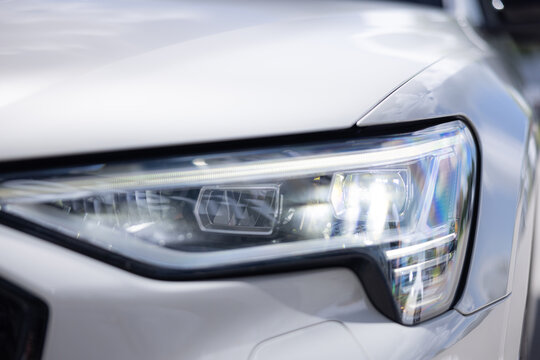 Riga, LATVIA - July 09, 2026: Close-up view of Audi e-tron headlight showcasing modern design and advanced lighting technology on a sleek electric vehicle