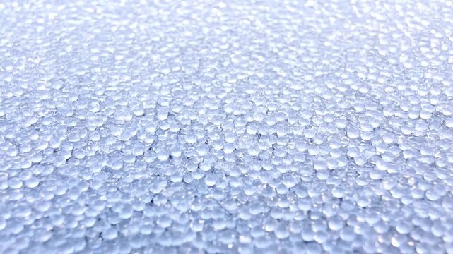 Close View of Translucent Ice Pellets Covering a Cold Textured Surface